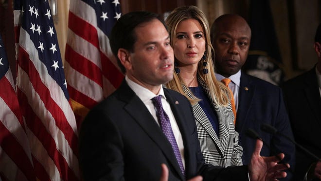 Sen. Marco Rubio, R-Florida, speaks as Ivanka Trump and Sen. Tim Scott, R-S.C., listen during a news conference Wednesday, Oct. 25, 2017, at the Capitol in Washington, D.C. Trump joined Republican legislators to discuss child tax credit.