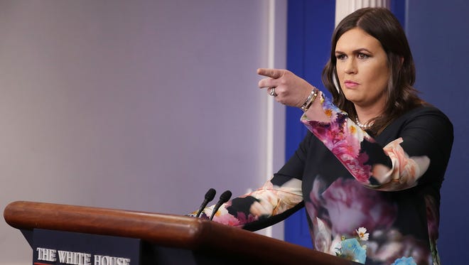 White House Press Secretary Sarah Huckabee Sanders takes reporters' questions during a White House briefing Friday. Sanders fielded questions about sexual harassment allegations against Judge Roy Moore, Sen. Al Franken and President Donald Trump.