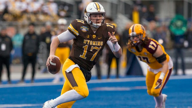 Wyoming quarterback Josh Allen runs with the ball against Central Michigan during the Famous Idaho Potato Bowl on Dec. 22, 2017.