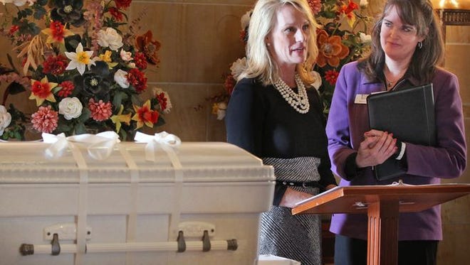 Linda Znachko, left, introduces Marian Borondy, from Washington Park East, who will lead the "Prayer for the sorrowful," during a memorial service for two dead babies, at Washington Park East Cemetery, Saturday, January 17, 2015. One baby, abandoned last month in the woods, dubbed Amelia Grace Hope, and the other baby, drowned in a bathtub, dubbed Baby Harmoni, were memorialized at the cemetery chapel before Baby Amelia was buried at the cemetery. Baby Harmoni will be cremated. The burial plots, headstone, caskets, and burial gowns were donated.