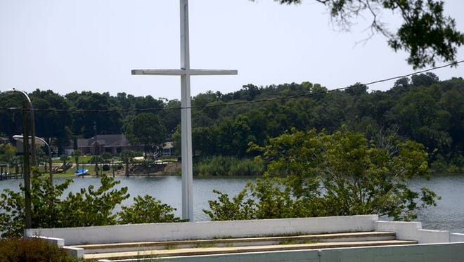 A Washington, D.C., advocacy group is calling for the removal of the large cross at Bayview Park and threatening legal action if the city does not comply.