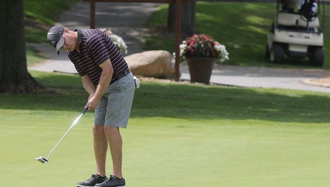 Tim Phipps putts on the 18th green Friday, July 10 during the Port Huron Elks 2015 Men's Invitational in Port Huron Township.