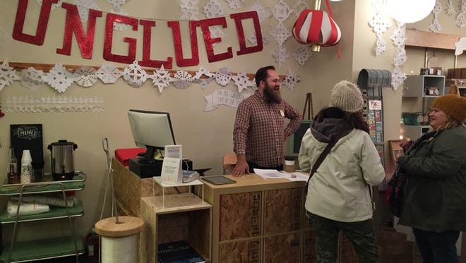 Justin Morken chats with customers at Unglued during a soft opening Wednesday night.
