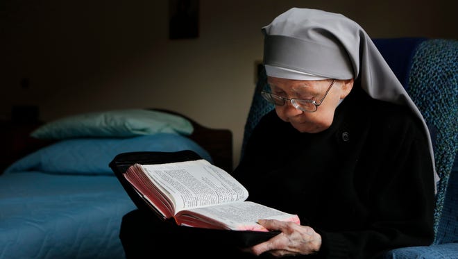Sister Catherine, 92, sat in her room at the St. Joseph's Home and read from a prayer book.