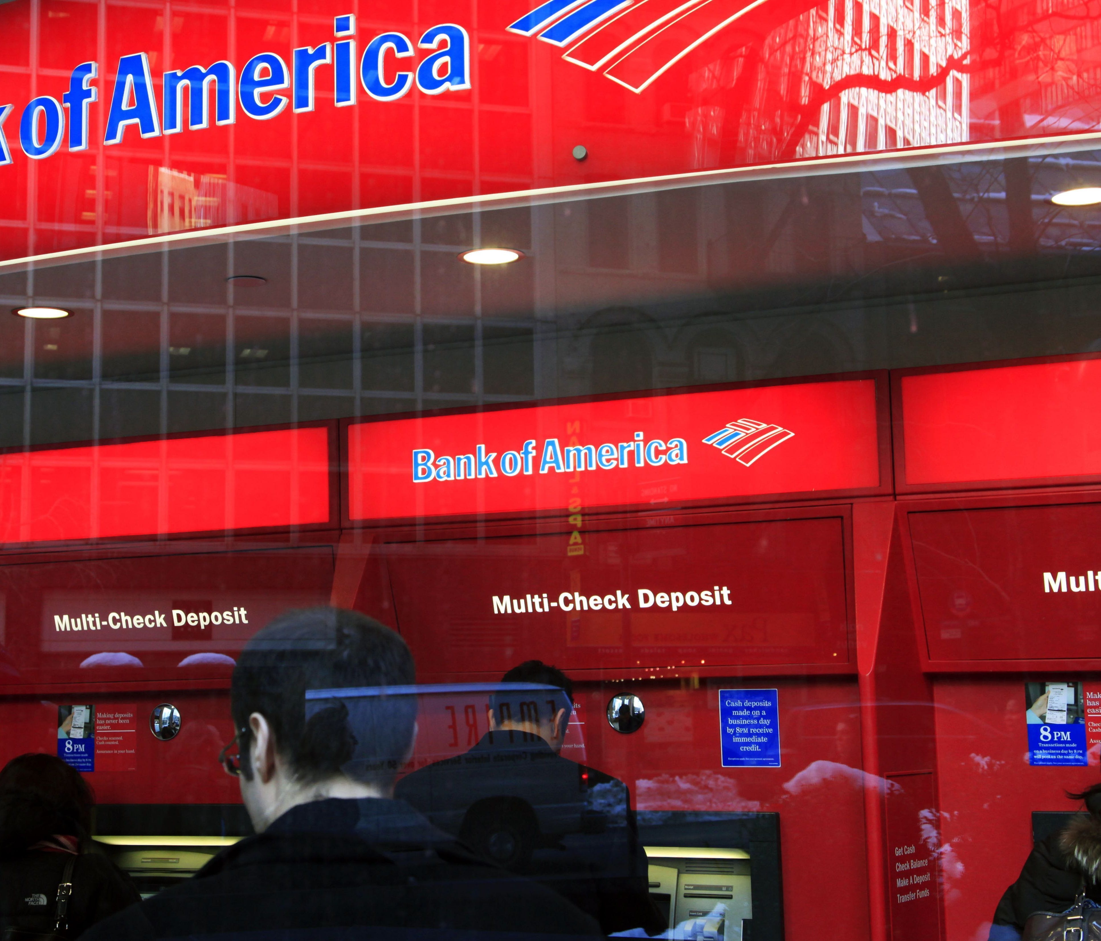 In this Jan. 31, 2011 photo, Bank of America customers use ATM machines in New York.  (AP Photo/Mark Lennihan)