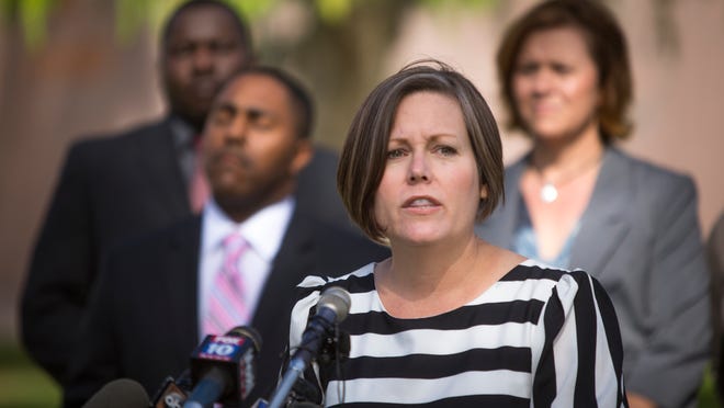 State Sen. Katie Hobbs speaks at a news conference outside of the State Capitol in support of Shanesha Taylor on Tuesday, April 15, 2014. Shanesha Taylor is facing charges of child abuse after leaving her 2 young children in a hot car while she went for a job interview.