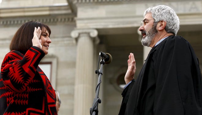 Denise Juneau is sworn in as superintendent of public schools by Chief Justice Mike McGrath on the steps of the Montana State Capitol in 2013.