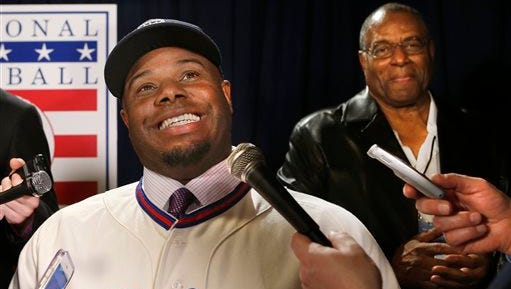 Newly-elected Baseball Hall of Fame member Ken Griffey Jr. conducts interviews with his father, Hall of Famer Ken Griffey Sr. listening in after a press conference announcing that he and Mike Piazza  were elected to baseball's Hall of Fame, Thursday, Jan. 7, 2016, in New York.