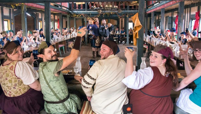 Feast-goers toast to their merry hosts at the Minnesota Renaissance Festival.