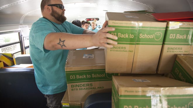 Community volunteers, employees of Allconnect and organizers from United Way fill a school bus with school supplies donated by area businesses and residents Thursday. Organizers of the drive said they typically run short on backpacks and jump drives, and are always in need of hygiene products for high school students. Donations can be made at the Washington County School District Administration Building in St. George.