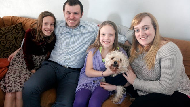
Ryan Craig, 25, of Newtown, with his wife, Megan, 24, and his twin sisters, Isabelle, 10, and Elizabeth, 10, along with their family dog, Reese. A little over two years ago, Ryan and his sister's mother passed away, leaving Ryan to make the choice to file for legal guardianship since the girls' father was no longer in the picture. Ryan and Megan have embraced the role of legal guardians of the girls. 
