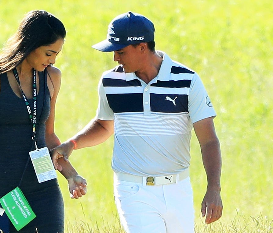 HARTFORD, WI - JUNE 14:  Rickie Fowler of the United States walks along the course with Allison Stokke during a practice round prior to the 2017 U.S. Open at Erin Hills on June 14, 2017 in Hartford, Wisconsin.  (Photo by Andrew Redington/Getty Images