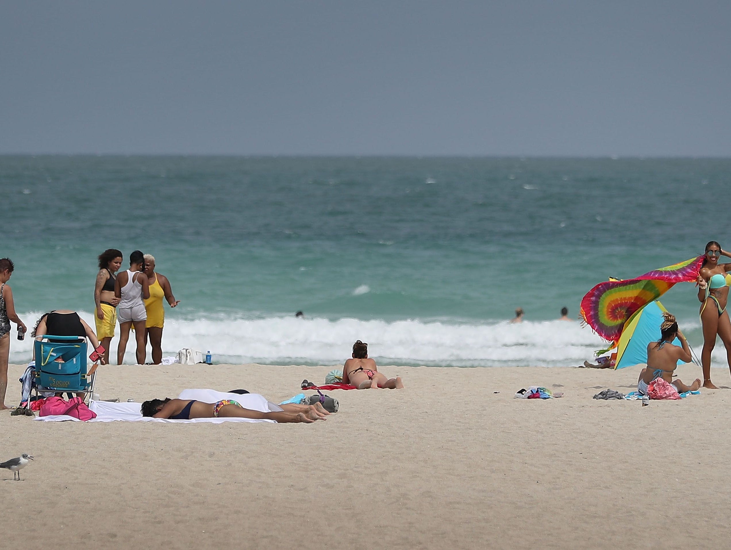 People enjoy themselves on the beach in Florida.