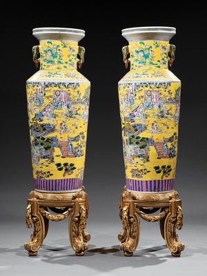 This 60-inch-high pair of Chinese clobbered famille rose porcelain vases from the 19th or 20th century sold for $4,780 at Neal auction in New Orleans recently. They have multicolored decorations and a yellow ground.