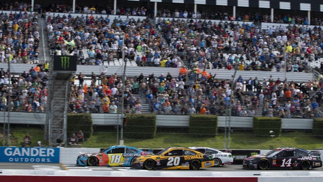 Kyle Busch (18) leads Erik Jones (20) on a restart during the NASCAR Cup Series race at Pocono Raceway, Sunday, June 2, 2019, in Long Pond. NASCAR will hold its 2020 events at Pocono Raceway without fans due to the coronavirus pandemic.