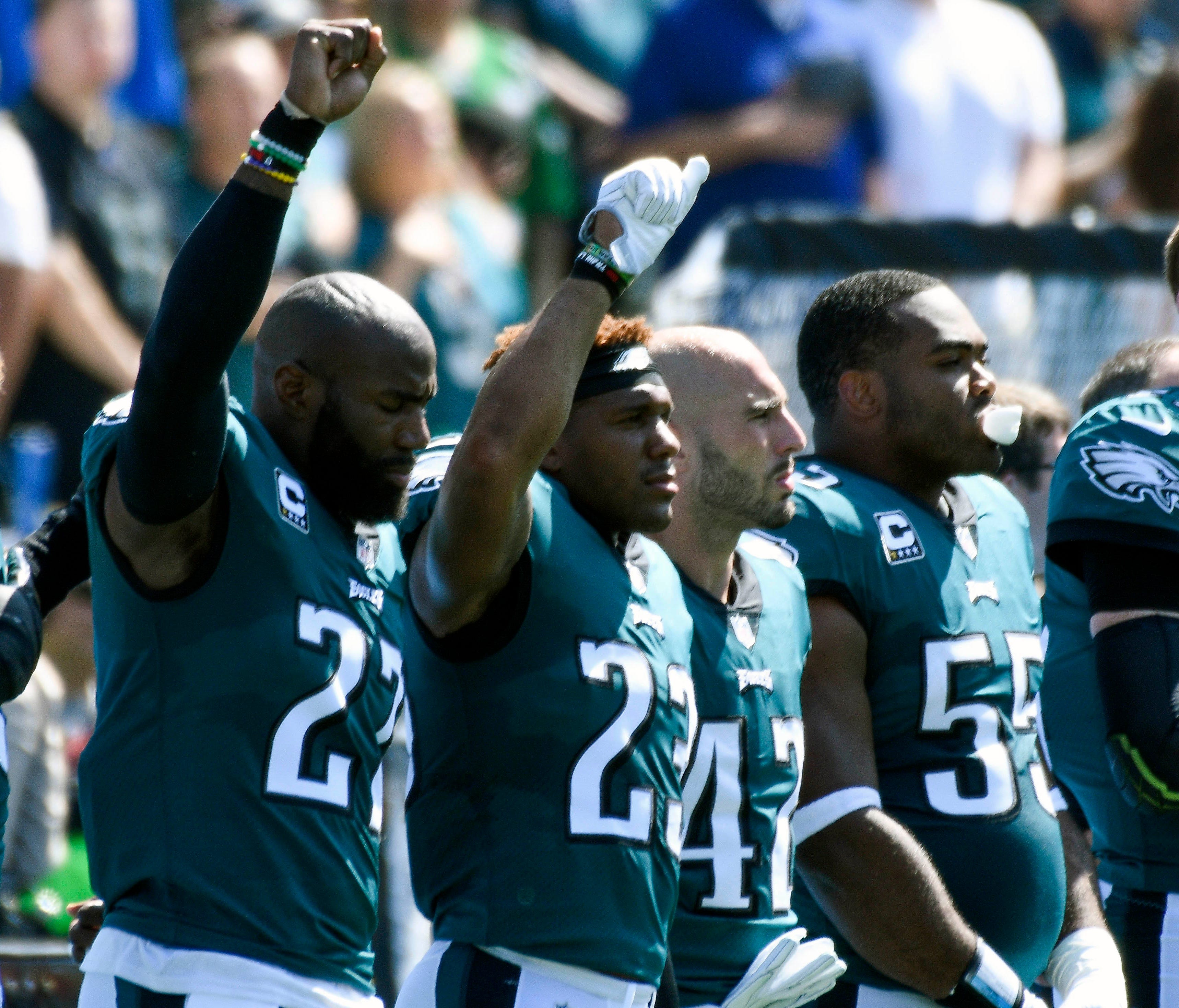 Philadelphia Eagles strong safety Malcolm Jenkins (27) and free safety Rodney McLeod (23) raise a fist in the air during the national anthem before the kickoff of their game against the Los Angeles Chargers at StubHub Center.
