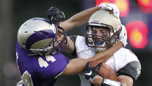 Clarkstown South's Kyle Samuels (4) is tackled by Clarkstown North defensive back Brian Fuller (44) in the first half of their football game at Clarkstown North High School in New City on Friday, September 02, 2016. Clarkstown South won 14-13 taking the supervisors trophy.