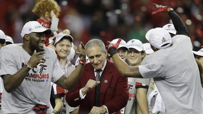 Falcons owner Arthur Blank dances with players after the NFC championship game against the Packers on Sunday in Atlanta.