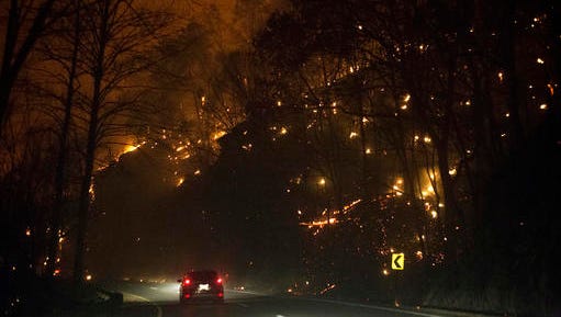 Fire erupts on both side of Highway 441 between Gatlinburg and Pigeon Forge, Tenn., Monday, Nov. 28, 2016. In Gatlinburg, smoke and fire caused the mandatory evacuation of downtown and surrounding areas, according to the Tennessee Emergency Management Agency.