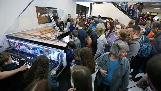 The public is invited to approach the piano-shaped fish tank after the filming of an episode of of the television show "Tanked" wat the Piano Works Mall in East Rochester.