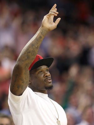 Houston Texans wide receiver Andre Johnson acknowledges the crowd during the second half of an NBA basketball game between the Houston Rockets and the Memphis Grizzlies, Wednesday, March 4, 2015, in Houston. The Grizzlies won 102-100. (AP Photo/Pat Sullivan)