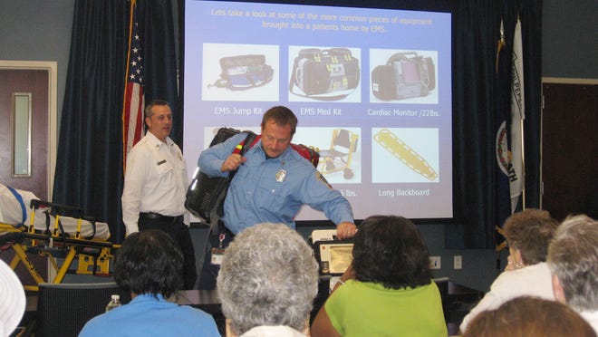 Culpeper County Emergency Services Lt. Bill Ooten, left, and firefighter Pete Read, center, as the participate in a community discussion about hoarding in Culpeper, Va. They emphasized that in emergencies it can be difficult to impossible to get all their gear into a hoarded home.