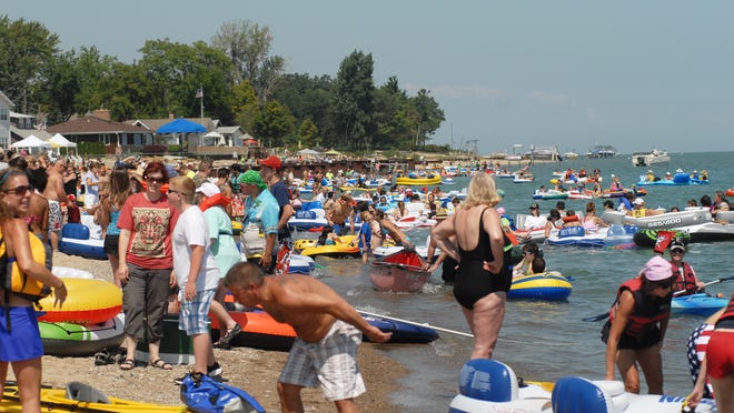 Participants gather at Port Huron’s Lighthouse Beach to start their journey at a previous St. Clair River Float Down.