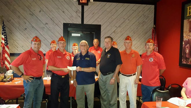 Presenting a $1,000 check to Tennessee State Veterans Cemetery Steering Committee Chair Chris Dangler and Committee Member Ray Parish: From left to right, front row Thom Corley, Bryce West, Chris Dangler, Ray Parsh, J.D. Williams, Keith Guinn, back row, Carrie Mercer, Vic Corson, J.C. Jones, and Casey Palmer.