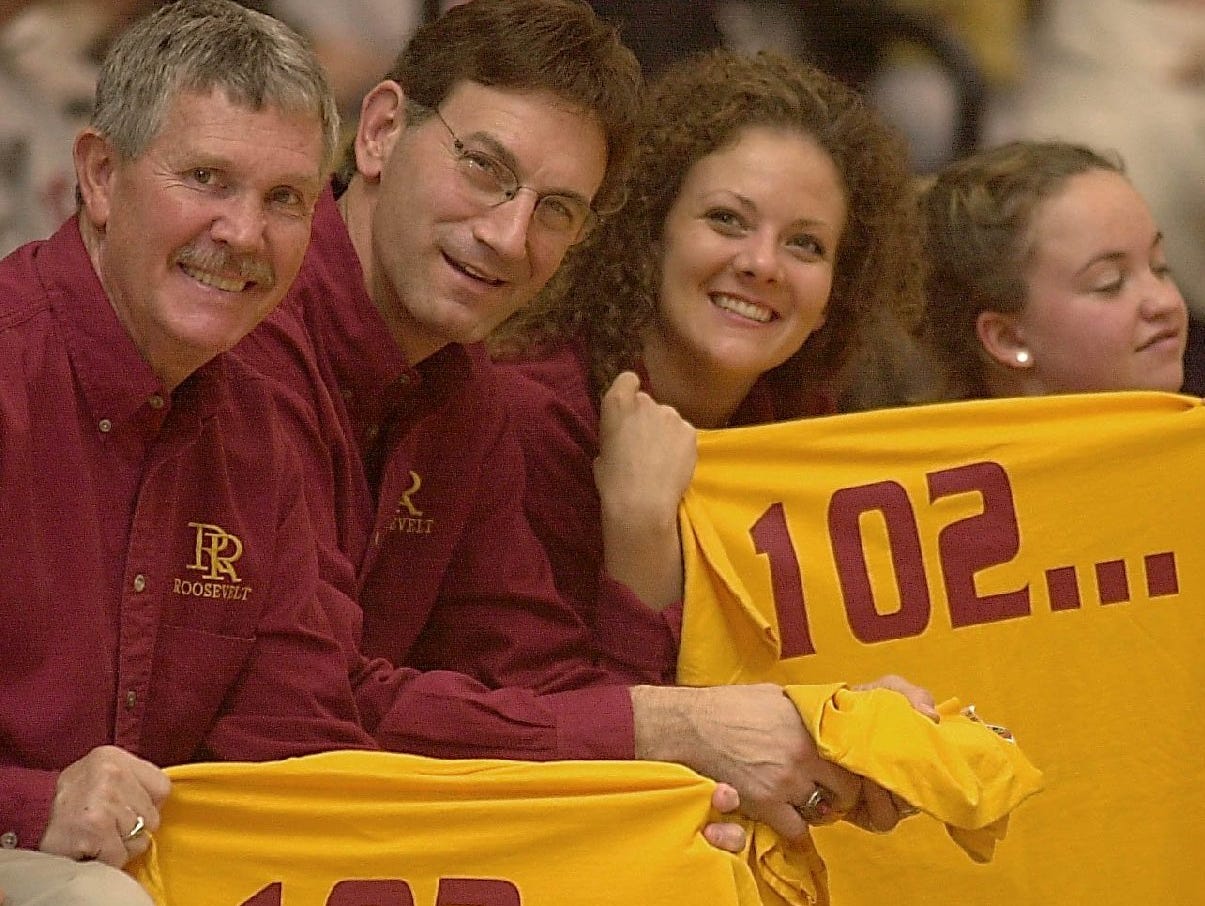 Roosevelt coaches Larry Toft, Fred Tibbetts and Denise Klein hold up their 102 win shirts as the final seconds tick off the clock in Sturgis.
