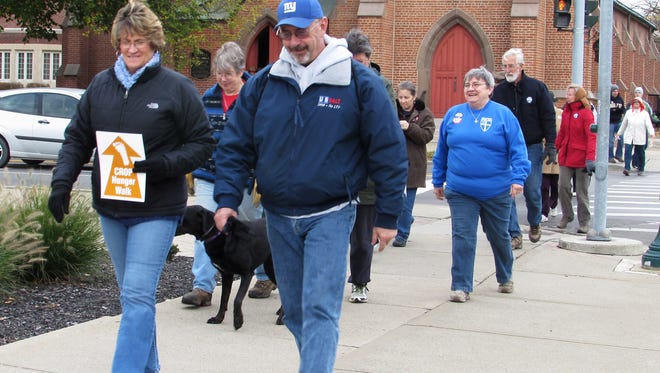 Participants in Sunday's Elmira-Horseheads CROP Hunger Walk leave Trinity Episcopal Church in downtown Elmira and walk down Church Street.