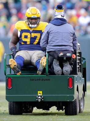 Green Bay Packers nose tackle Kenny Clark (97) is carted