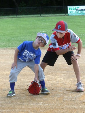 Blue team infielder Ryan Roper gets some fielding advice