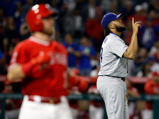 Los Angeles Dodgers relief pitcher Kenley Jansen, right, points to the sky after striking out Los Angeles Angels' Cliff Pennington, right, during the ninth inning of a baseball game in Anaheim, Calif., Thursday, June 29, 2017. The Dodgers won 6-2. (AP Photo/Alex Gallardo)