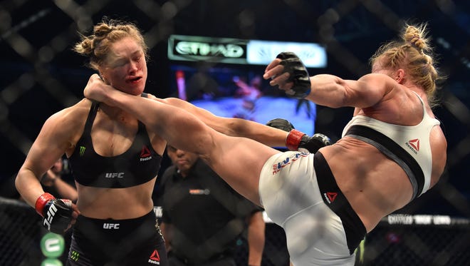 This file photo taken on November 15, 2015 shows Holly Holm of the U.S. landing a kick to the neck to knock out compatriot Ronda Rousey and win the UFC title fight in Melbourne on November 15, 2015.