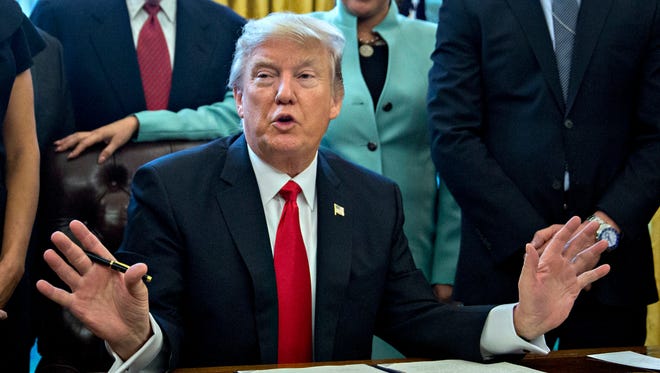 WASHINGTON, DC - JANUARY 30:  (AFP OUT) U.S. President Donald Trump speaks before signing an executive order surrounded by small business leaders in the Oval Office of the White House January 30, 2017 in Washington, DC. Trump said he will "dramatically" reduce regulations overall with this executive action as it requires that for every new federal regulation implemented, two must be rescinded. (Photo by Andrew Harrer - Pool/Getty Images)
