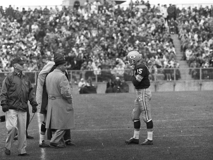 Green Bay Packers quarterback Bart Starr huddles with coach Vince Lombardi during the Packers’ 35-17 victory over the Los Angeles Rams at new City Stadium on Nov. 19, 1961.