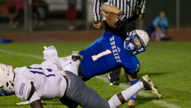 Reno Huskies quarterback Isaac Terrasas dives into the endzone for a touchdown in the second quarter against Spanish Springs Cougars during their football game played on Friday, October 16, 2015 at Reno High School in Reno, Nevada.