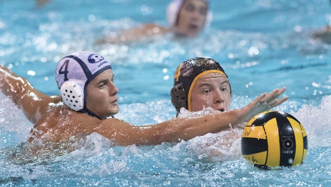 Redwood's Jared Cook, left, and Golden West's Brandon Green battle in boys water polo on Tuesday, September 27, 2016.