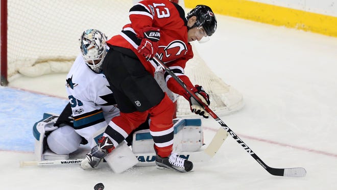 San Jose Sharks goalie Martin Jones (31) defends his net as New Jersey Devils left wing Michael Cammalleri (13) plays the puck during the first period of an NHL hockey game, Sunday, Feb. 12, 2017, in Newark, N.J. (AP Photo/Mel Evans)