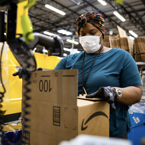 An Amazon employee working in a fulfillment center