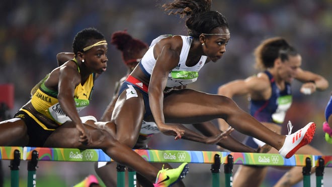 Great Britain's Cindy Ofili, center, qualified for Wednesday's final in the 100 hurdles. She is from Ypsilanti.