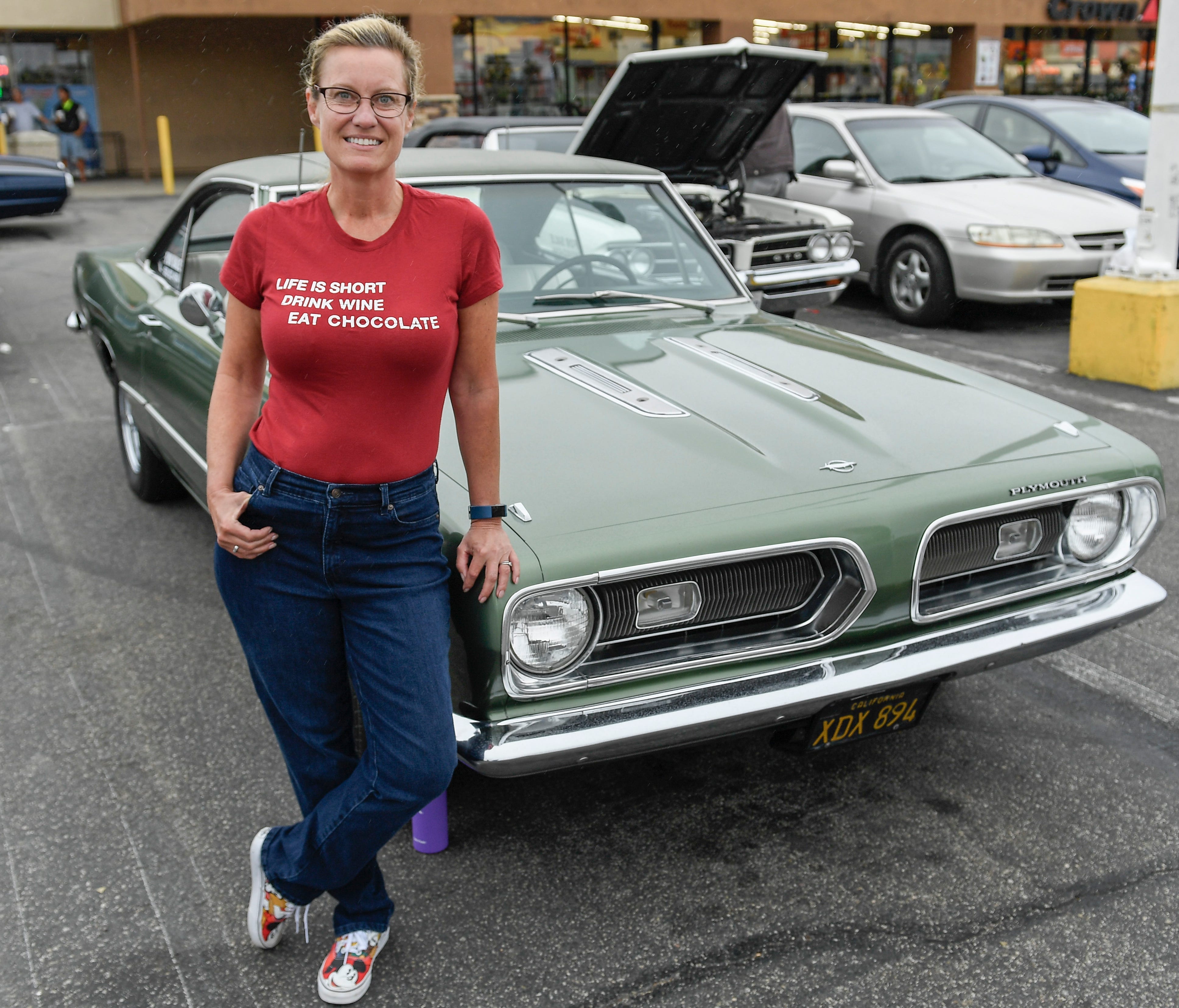 Maria Shrout with her classic Plymouth Barracuda at a car show in Huntington Beach, Calif.