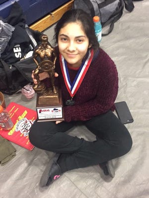 Yadira Ortiz of Sturgeon Bay with the trophy she earned for placing second in the girls 44-kilo (97-pound) class at the Wisconsin high school powerlifting championships.