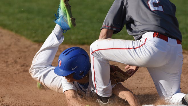 Zanesville's Brandon Pritchard slides safely into third with a stole base against Dover Wednesday.