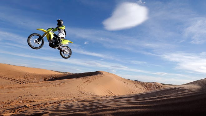 Jareth McHatton launches over a dune Dec. 11 at Red Sands in far East El Paso. The county is considering closing the popular recreation area.