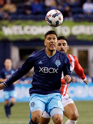Seattle Sounders' Tony Alfaro eyes the ball in front of Club Necaxa's Maximiliano Barreiro during the first half of Saturday's game.