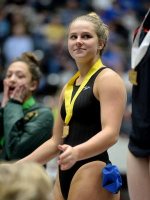 Centerville High School's Brooke Madden smiles from the podium during the IHSAA diving state finals Saturday, Feb. 13, 2016 at the IU Natatorium on the campus of IUPUI in Indianapolis.