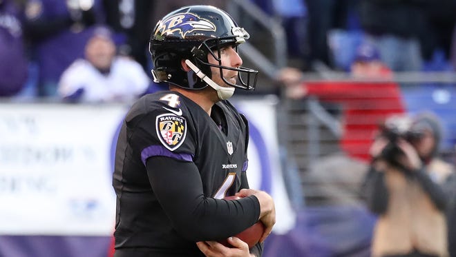 Punter Sam Koch of the Baltimore Ravens holds the ball for a safety against the Cincinnati Bengals in the fourth quarter at M&T Bank Stadium on November 27, 2016 in Baltimore, Maryland.