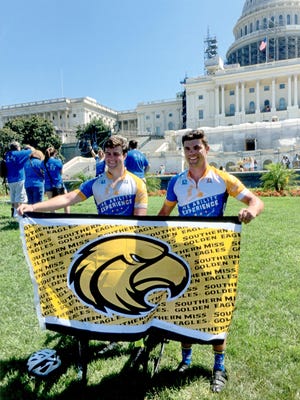 Josh Luke, right, and Shane Freeman pose with a Southern Miss banner in front of the Capitol Building in Washington, D.C., after completing the 4,300-mile Journey of Hope cross-country cycling event in August. The 71-day ride began in Seattle, Washington, before concluding in the nation's capital.