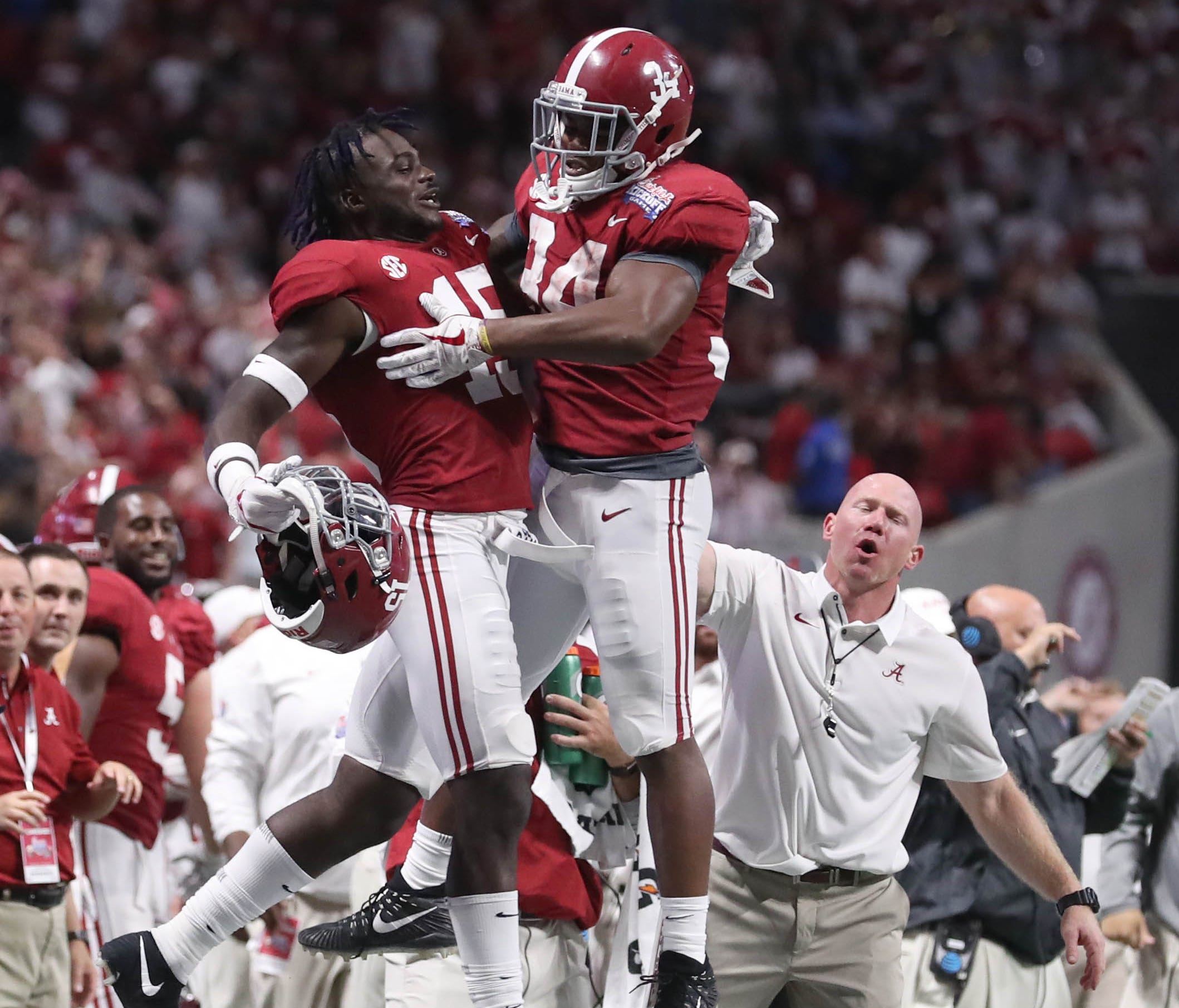 Alabama running back Damien Harris celebrates with defensive back Ronnie Harrison after scoring a touchdown in the third quarter against Florida State at Mercedes-Benz Stadium.